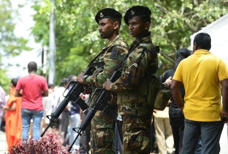 Soldiers stand guard at Mahinda Rajapakse's residence after he was sworn in as prime minister