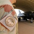 A member of the Barkhane mission standing next to a French air force Mirage in Niamey