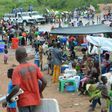 Congolese migrants who were living in Angola gather near the Congolese border town of Kamako on October 12, 2018, after returning to their country following a security crackdown by Angolan authorities