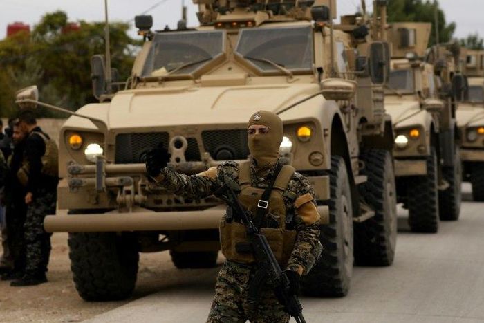 Members of the Syrian Democratic Forces (SDF)and US soldiers patrol the Kurdish-held town of Al-Darbasiyah in northeastern Syria bordering Turkey on November 4, 2018
