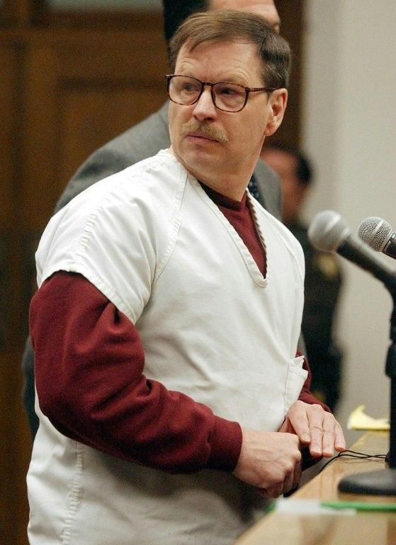 American Gary Ridgway, the "Green River Killer", looks over at relatives of his victims during his trial in a Seattle court in 2003