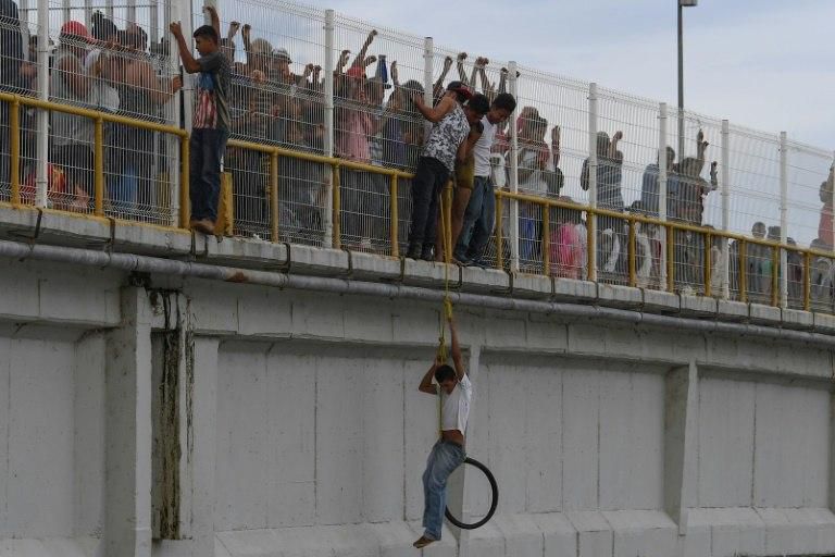 Some migrants packed onto the Guatemala-Mexico international border bridge opted to swim for it across the Suchiate river or board a raft to reach Mexico