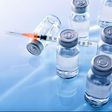 ___9080480___2018___11___7___14___vials-and-syringe-on-blue-table-top-elevated-royalty-free-image-867398442-1541534573