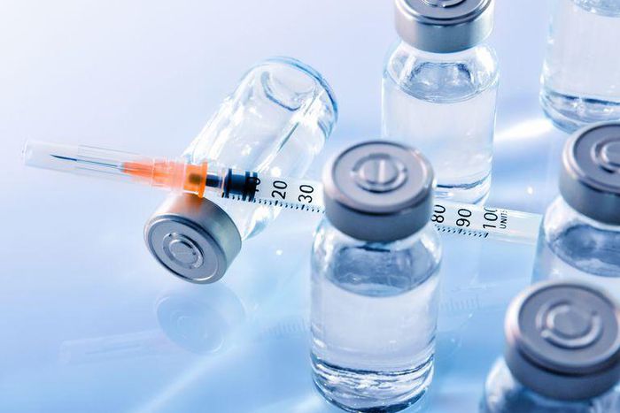 ___9080480___2018___11___7___14___vials-and-syringe-on-blue-table-top-elevated-royalty-free-image-867398442-1541534573