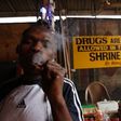 An unidentified man smokes weed at the New Afrikan Shrine in Lagos