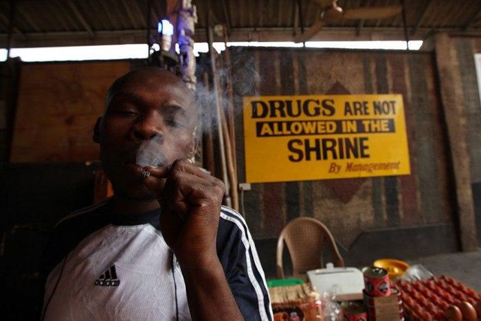 An unidentified man smokes weed at the New Afrikan Shrine in Lagos