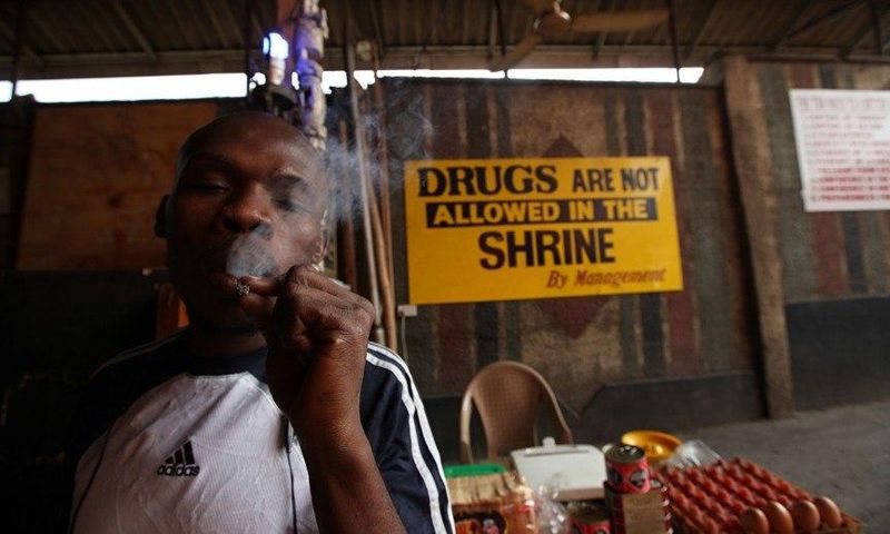 An unidentified man smokes weed at the New Afrikan Shrine in Lagos