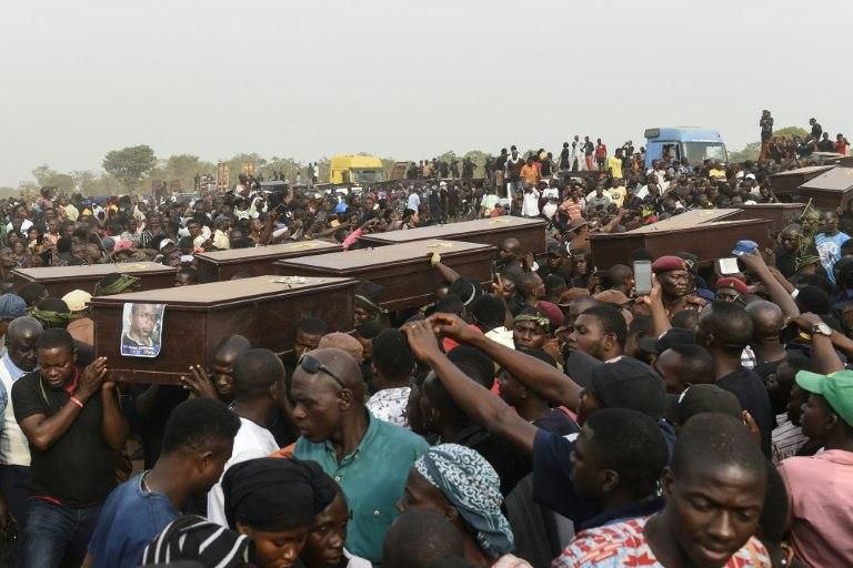 Pall bearers carry coffins of people killed in clashes between cattle herders and farmers in Benue state