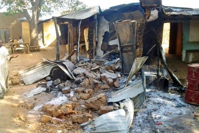 A resident inspects a burnt out house in Kizara village attacked by bandits who killed 48 people while early May saw dozens abducted in just two days on a road near the Zamfara state border
