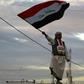 An Iraqi man waves his national flag in Baghdad's Tahrir Square on December 10, 2017, during a gathering celebrating the end of the three-year war against the Islamic State (IS) group