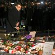 French President Emmanuel Macron lays a white rose at a monument near the Christmas market in Strasbourg, where four people where killed by a gunman this week