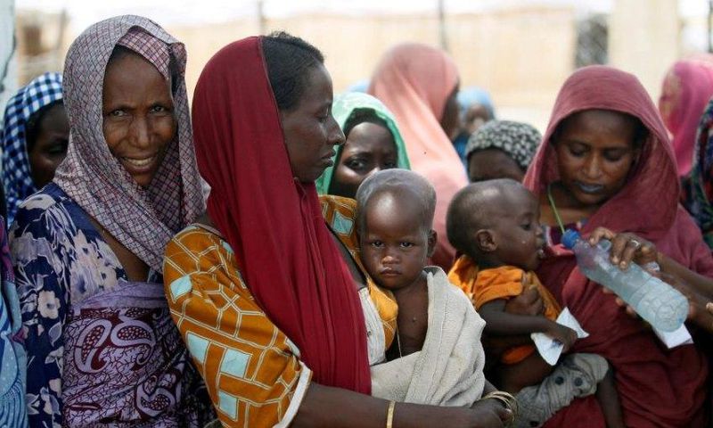 Women wait with their children under a shed for food rations at an internally displaced persons (IDP) camp on the outskirts of Maiduguri, northeast Nigeria June 6, 2017.