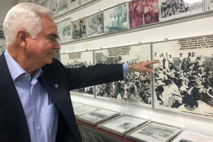 Johnny Lopez de la Cruz, a Cuban who is president of the Bay of Pigs Veterans Association, points to himself in a picture featured in the Brigade 2506 Museum in Little Havana, Miami