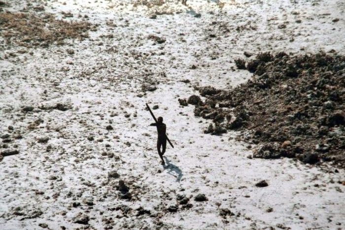 The few photos that exist of the Sentinelese, including this handout photo from 2004 provided by the Indian Coast Guard and Survival International, show them all but naked carrying spears, bows and arrows