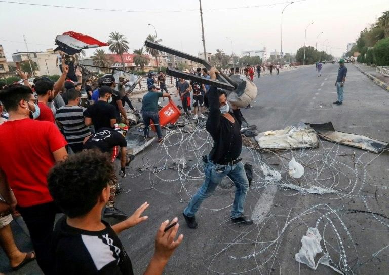 Protesters erect a makeshift barricade during clashes with Iraqi security forces after a demonstration against corruption and lack of basic services including electricity in the southern city of Basra