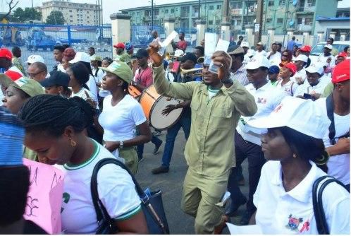 Youths sharing condoms while participating in the walk against HIV organized by 4YBY, LSACA and NIMR