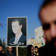 Syrian Kurds hold a portrait of President Bashar al-Assad during a demonstration in the northeastern city of Qamishli on December 23, 2018, seeking protection by the Syrian army against Turkey following a shock US decision to withdraw its troops