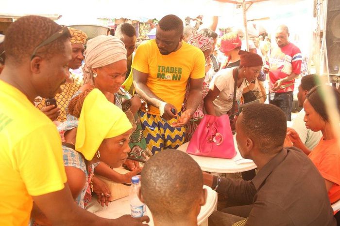 Traders at Oyingbo Market being attended to by the activation agents during the inauguration of TraderMoni across three makets in Lagos on Tuesday