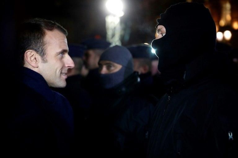 Macron meets with hooded police near the Christmas market in Strasbourg