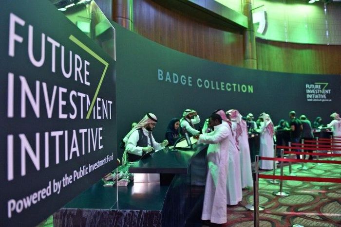 Saudi journalists collect their press badges for the Future Investment Initiative -- a key gathering overshadowed by the killing of critic Jamal Khashoggi