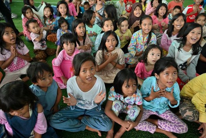 Children displaced by the tsunami play games to take their minds off the disaster