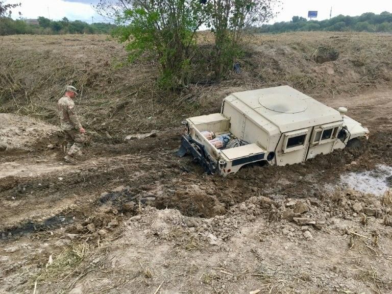 A military Humvee can be seen mired in the mud on the banks of the Rio Grande