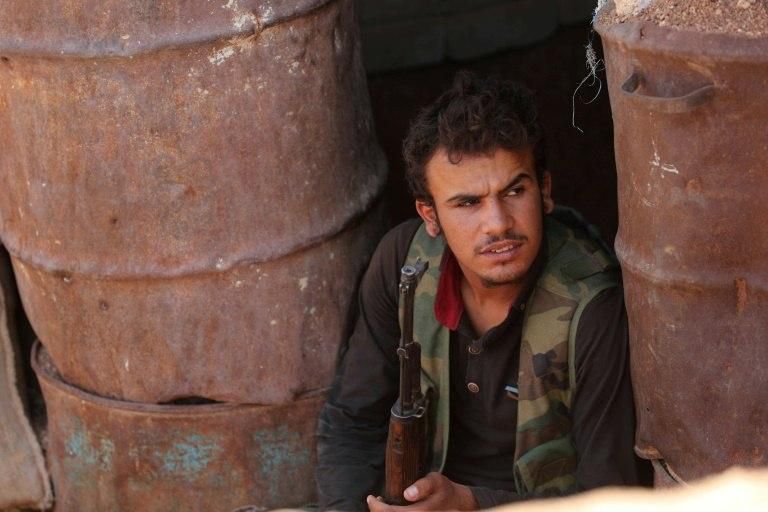 A rebel fighter takes position in a trench in the area of Al-Eis in northern Syria on October 7, 2018