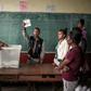 The big count: An electoral officer holds up a ballot paper as votes are tallied at a polling station in Antananarivo