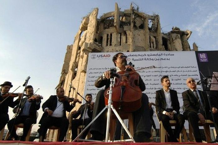 Renowned Iraqi maestro and cello player Karim Wasfi performs in Mosul's war-ravaged Old City on November 10, 2018