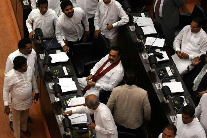 A majority of Sri Lanka's parliament supported a no-confidence motion against former president and currently appointed prime minister, Mahinda Rajapakse (C)