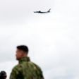 NATO forces on the USS Moutn Whitnes watch a Russian Tupolev TU-142 fly past
