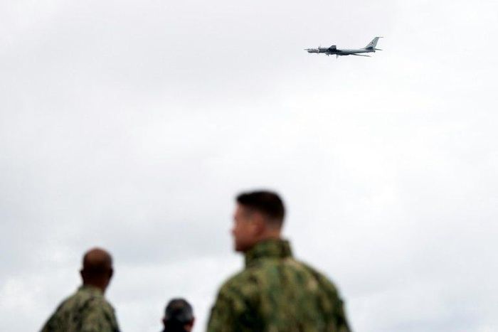 NATO forces on the USS Moutn Whitnes watch a Russian Tupolev TU-142 fly past