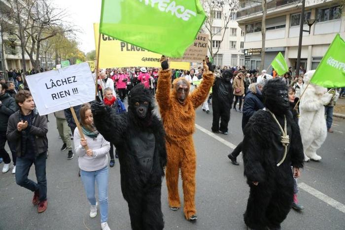 Activists from Greenpeace, one of the NGOs who accuse France of not respecting its short-term climate objectives, take part in a march for climate in Paris earlier this month