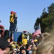 Firefighters salute as a motorcade passes by transporting the body of Sergeant Ron Helus, killed in a shooting at a country bar in Thousand Oaks, California