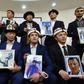 Kyrgyz family members hold portraits of their relatives who they fear are being held in notorious "re-education camps" in China's Xinjiang region