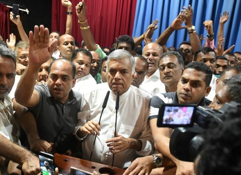 Ranil Wickremesinghe (C) had amended the constitution to remove the president's power to sack prime ministers