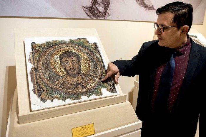 Director of the Cyprus Byzantine Museum Ioannis Eliades shows a centuries-old mosaic of Saint Mark in Nicosia on November 21, 2018