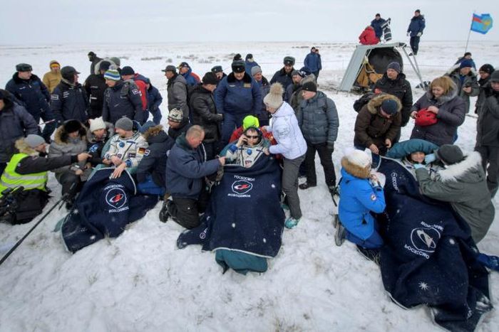 Rescuers pulled the crew members out of the capsule