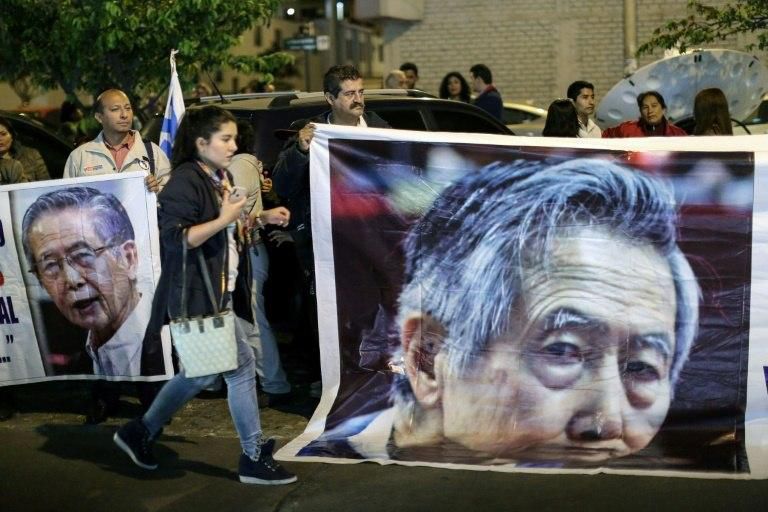 People backing Peruvian former president (1990-2000) Alberto Fujimori show their support outside the Centenario Clinic in Lima, on October 4, 2018