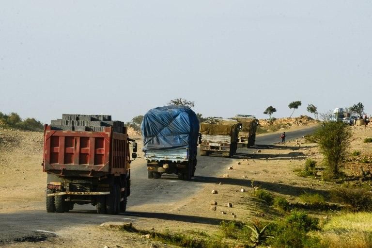 Horse-drawn carts, buses full of visitors and trucks piled high with bricks and plywood cross the border regularly
