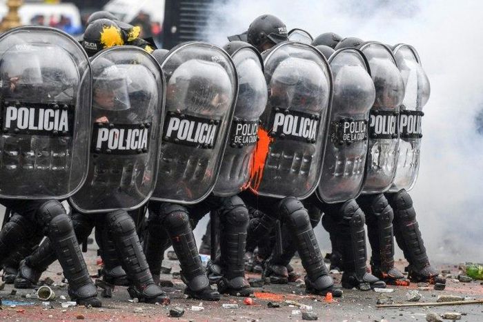 Riot police take position during clashes with demonstrators outside the Argentine Congress, where lawmakers approved a controversial austerity budget