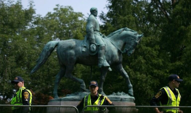Virginia State Police guard the statue of Confederate General Robert E. Lee in Charlottesville on the one year anniversary of deadly protests