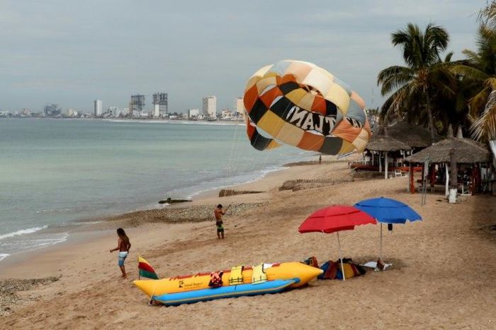 People enjoy the beach in Mazatlan, Mexico on October 21, 2018, ahead of an expected hit from Hurricane Willa