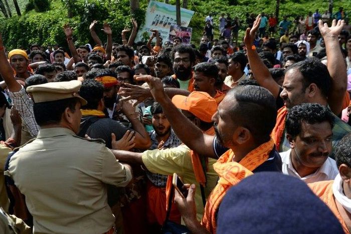 Police tried to clear protesters who are against allowing women into the site