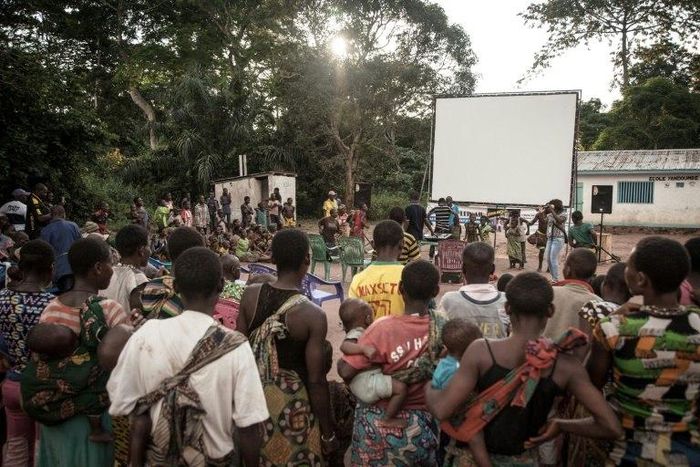 Many residents of a village of the Mbyaka (Pygmy) people gather in Bayanga after a trek for the cinema night