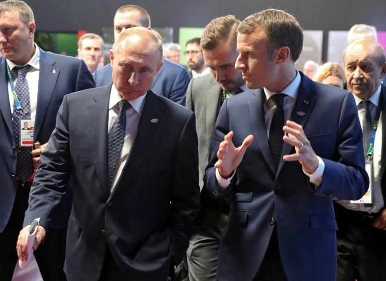 Putin (L) reportedly drew a map of the Kerch Strait off Crimea during a meeting with President Emmanuel Macron to support his claim that Ukrainian ships had intruded into Russian waters