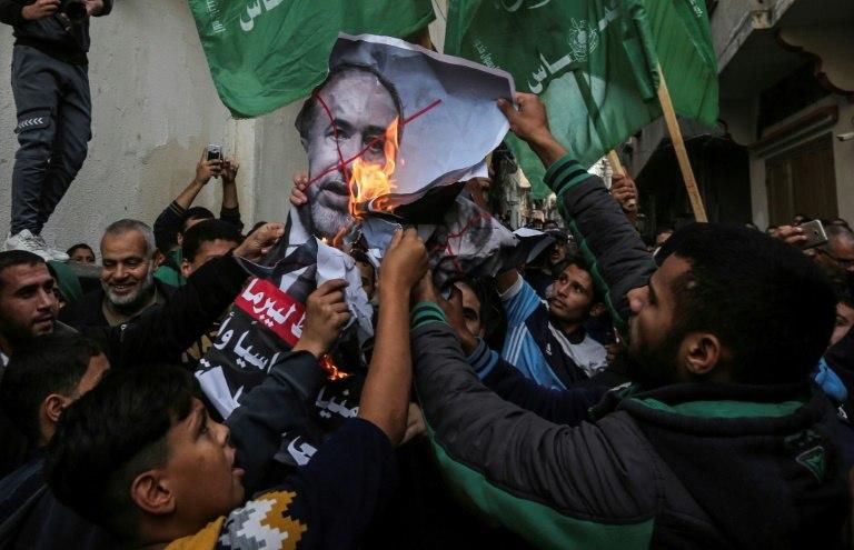 Palestinian demonstrators burn pictures of Israel's outgoing defence minister Avigdor Lieberman in Gaza on November 14, 2018