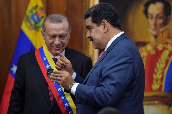 Venezuelan President Nicolas Maduro decorates Turkish President Recep Tayyip Erdogan with the Order of the Liberator in Caracas