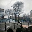 Protesters in Paris set fire to cars, burned barricades and smashed windows in pockets of violence, clad in their emblematic luminous safety jackets