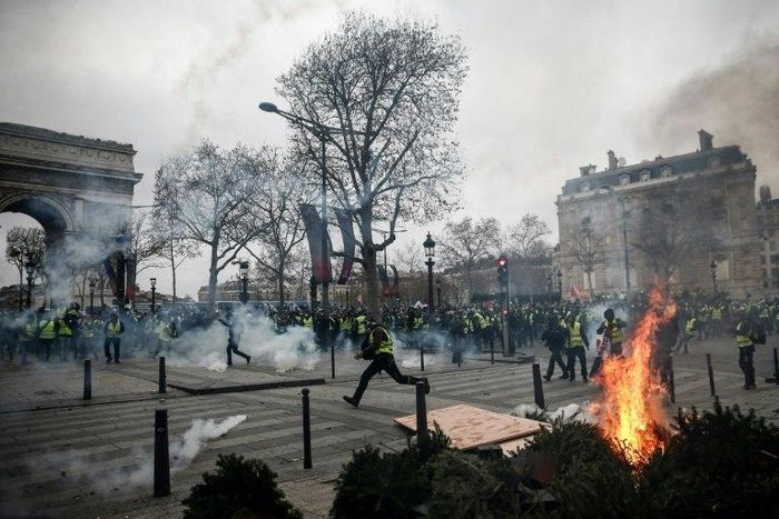 Protesters in Paris set fire to cars, burned barricades and smashed windows in pockets of violence, clad in their emblematic luminous safety jackets